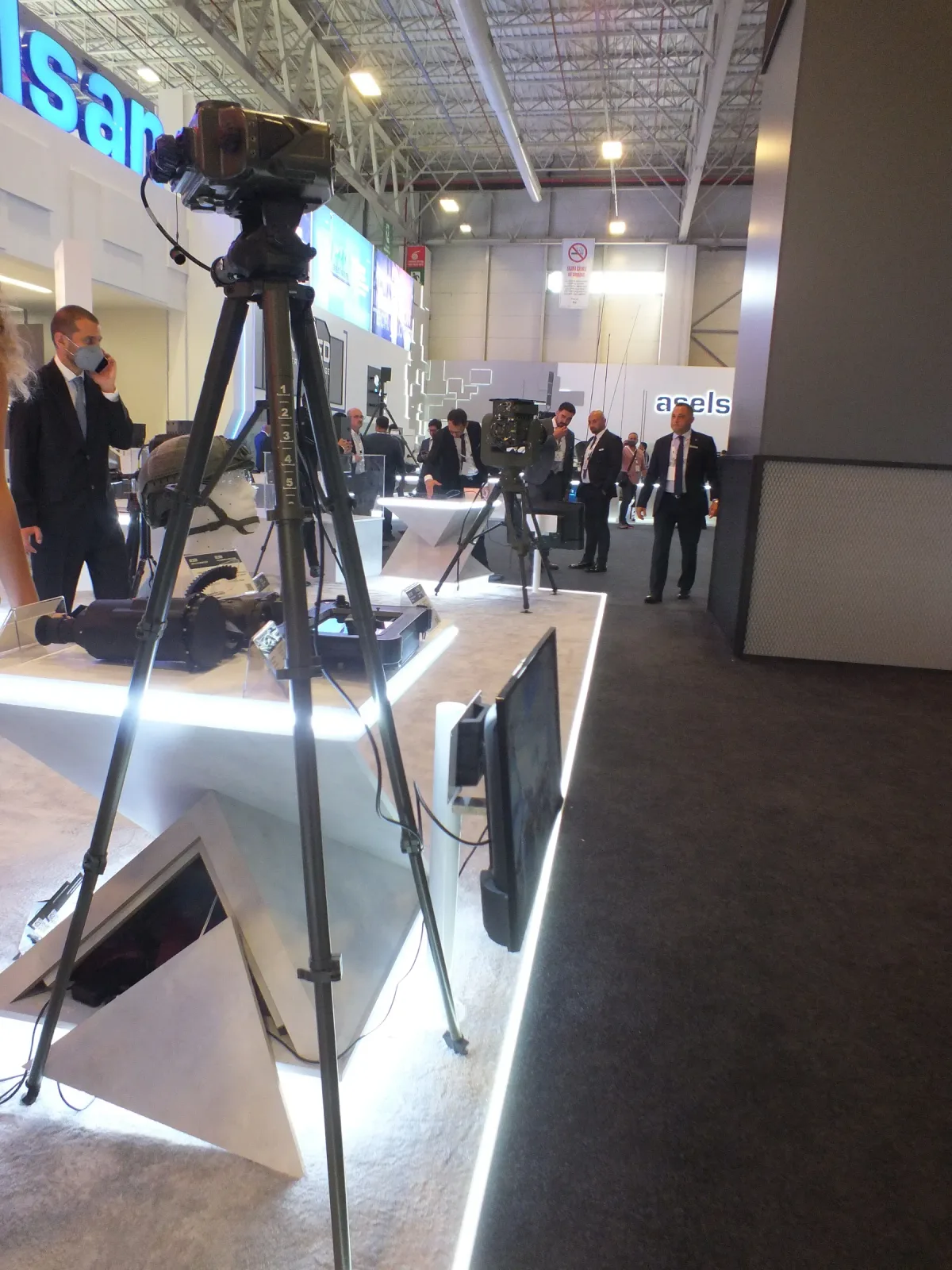 An ultra-light tripod carrying an observation payload on the exhibition floor.