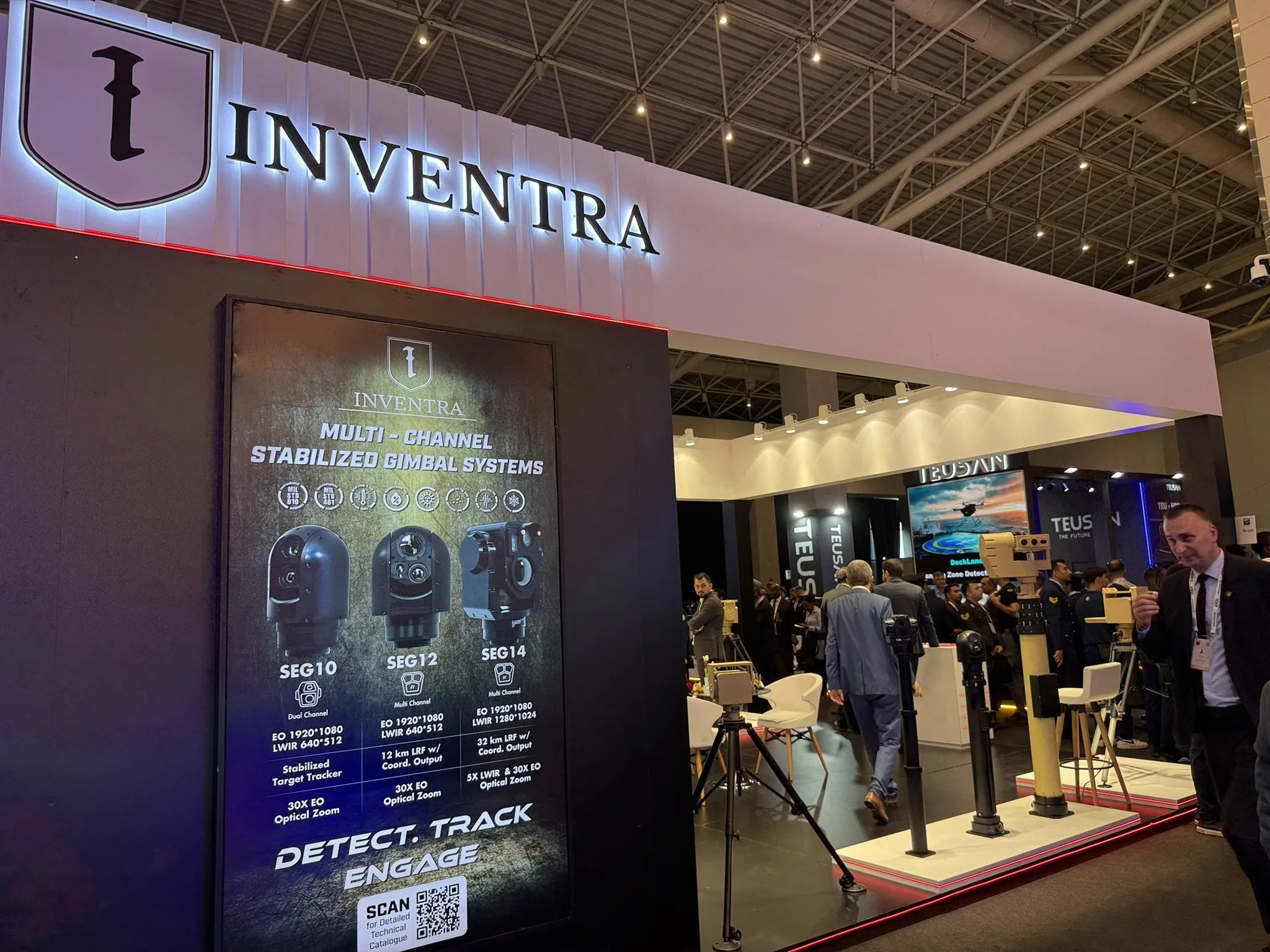 Corner of the stand with the banner for the SEG10, SEG12 and SEG14 multi-channel stabilised gimbal systems.