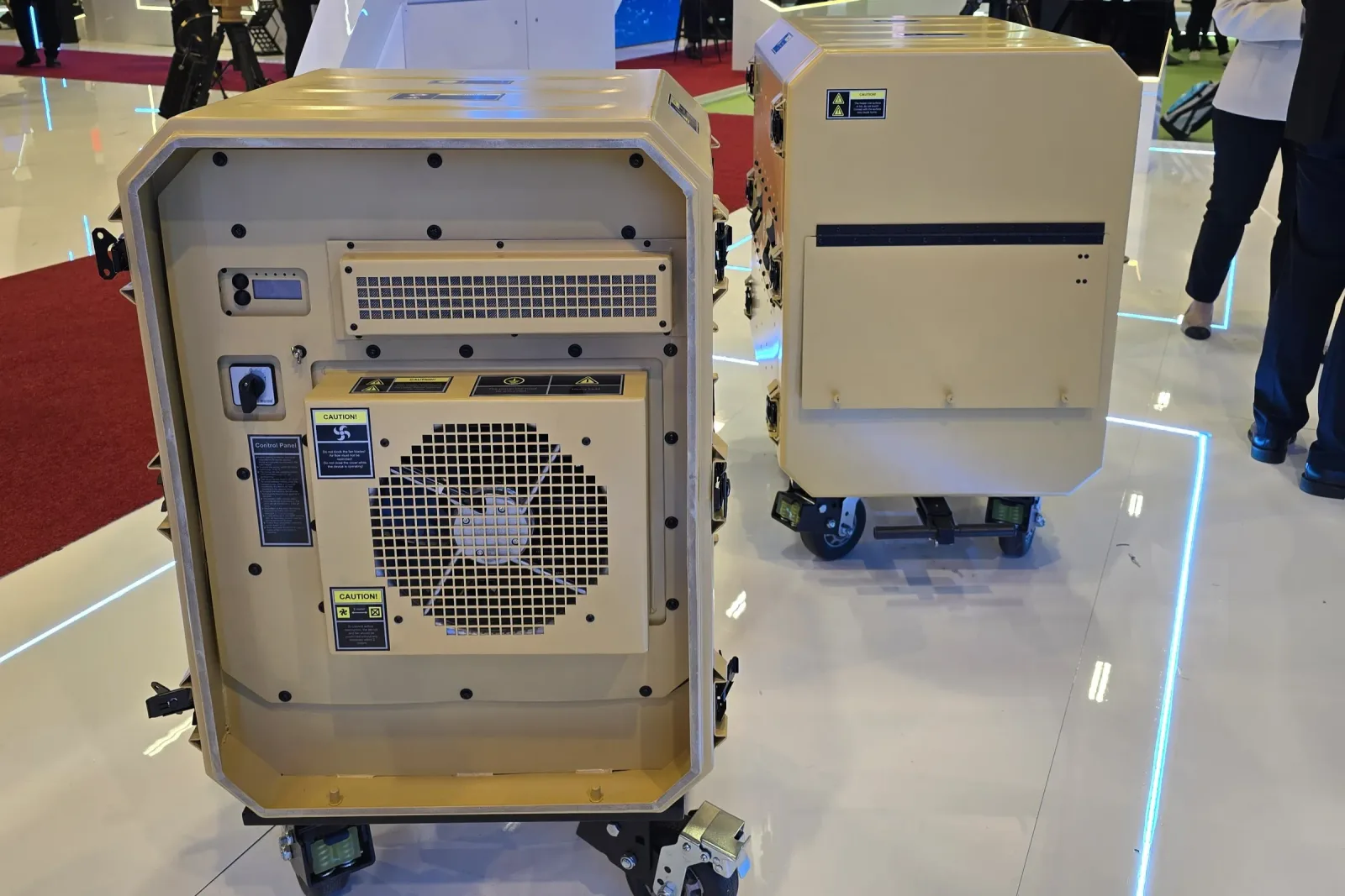 The front face of a rack cabin, with its control panel and ventilation grille visible; a second cabin stands behind it.