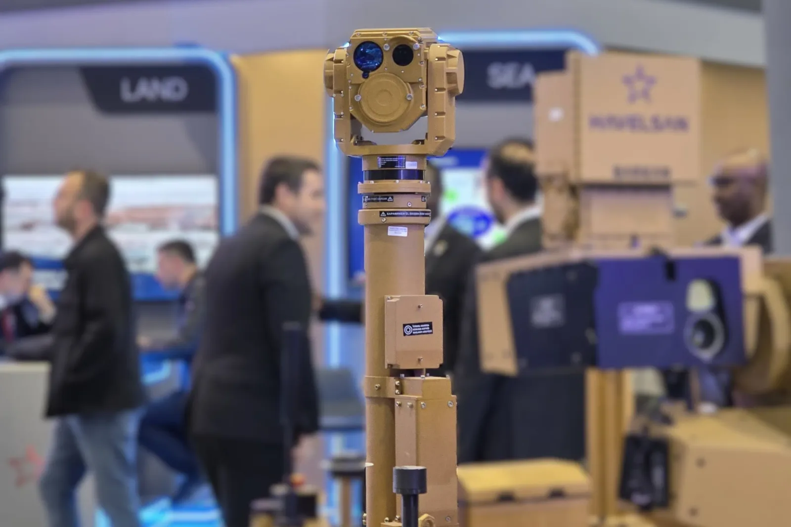 The gimbal on its mast above the crowd, photographed from the stand aisle.