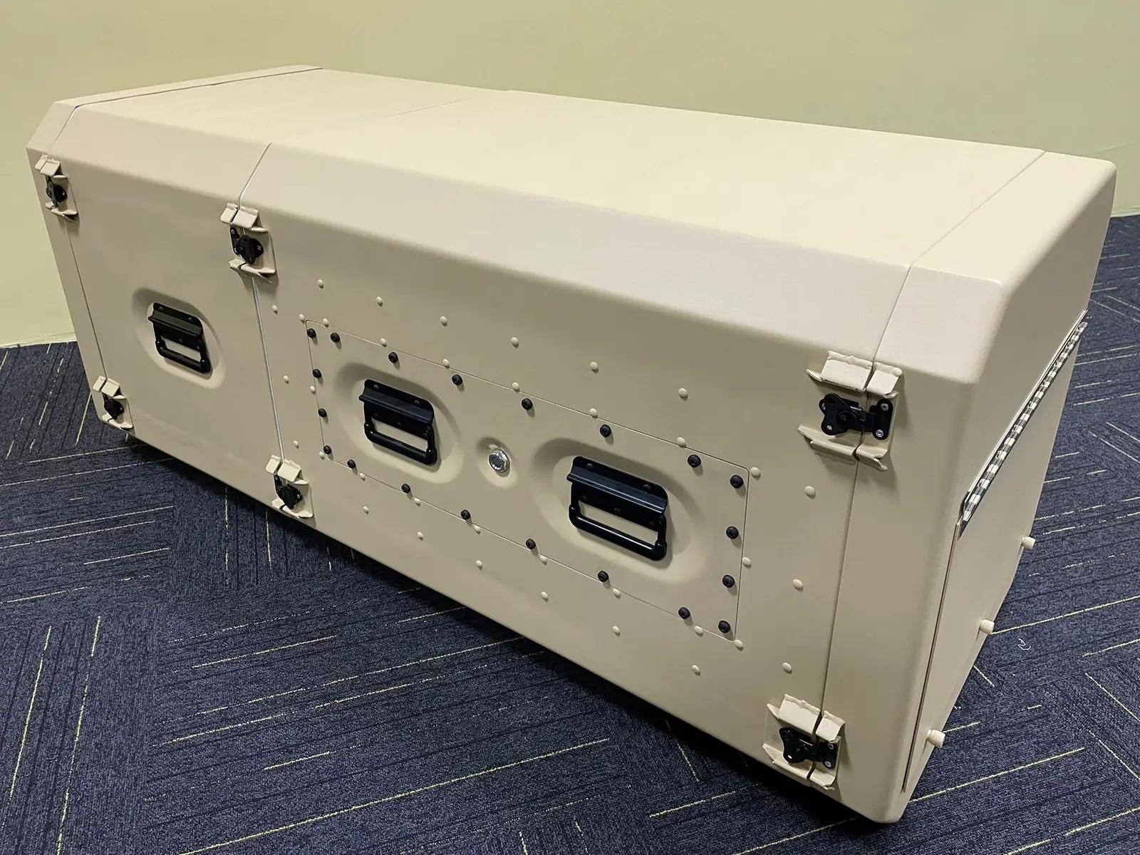 Climatic rack cabin at three-quarter angle showing the body, corner locks, handles and connector plate