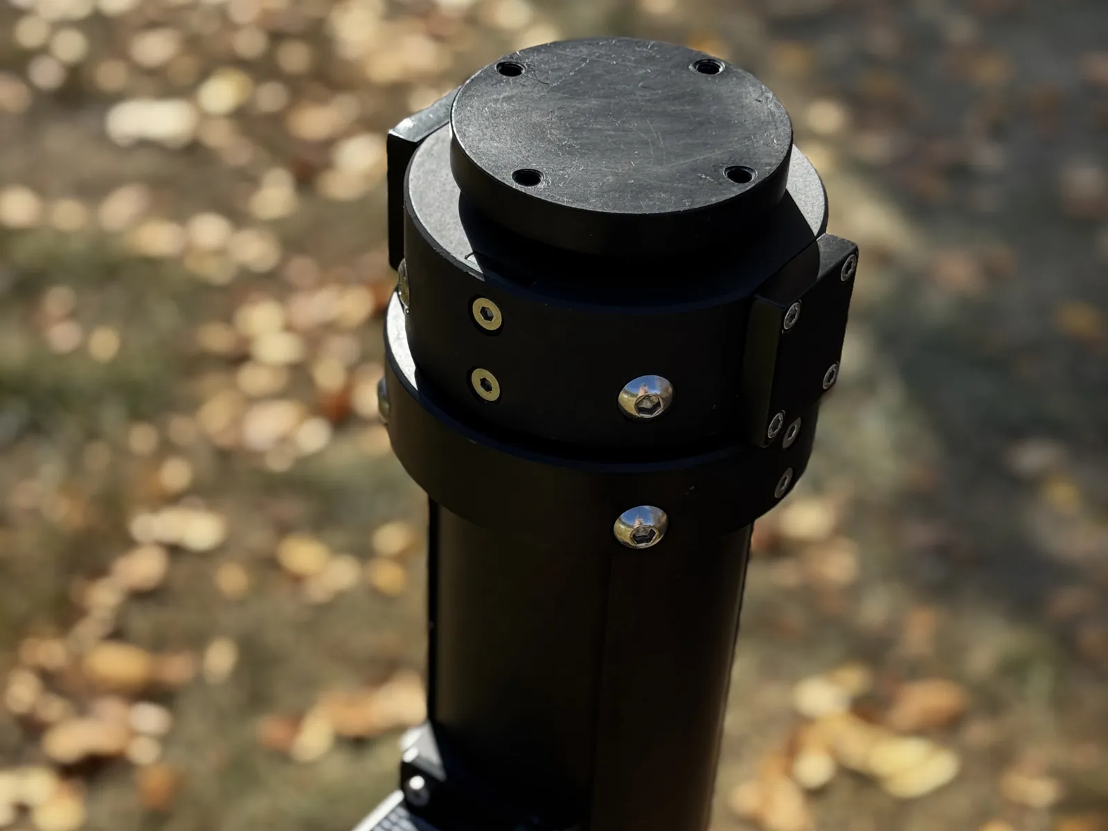 Upper payload interface at three-quarter angle: cover plate, locking ring and bolt pattern