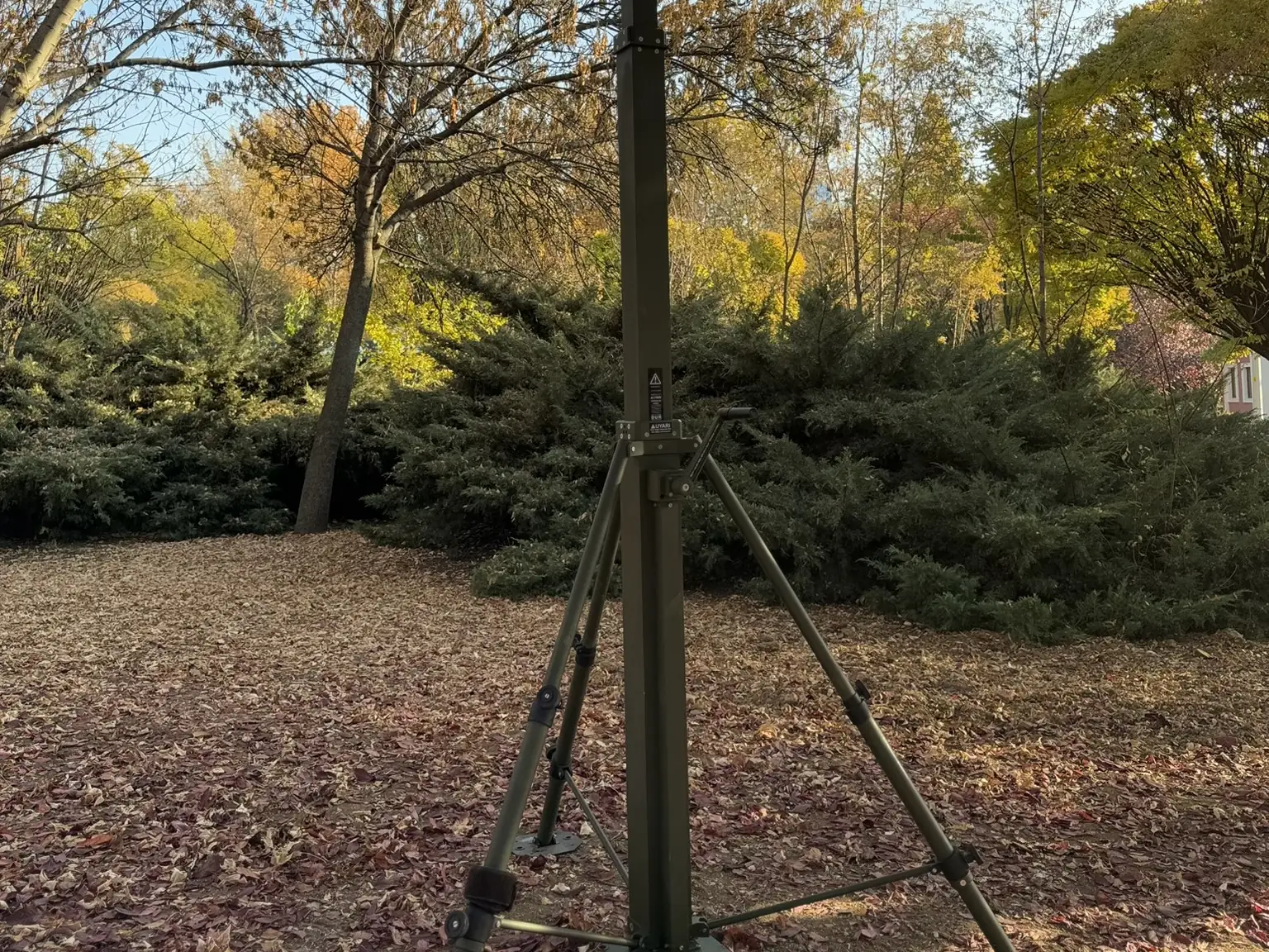 Mast fully deployed outdoors with its three legs and guy rods set up