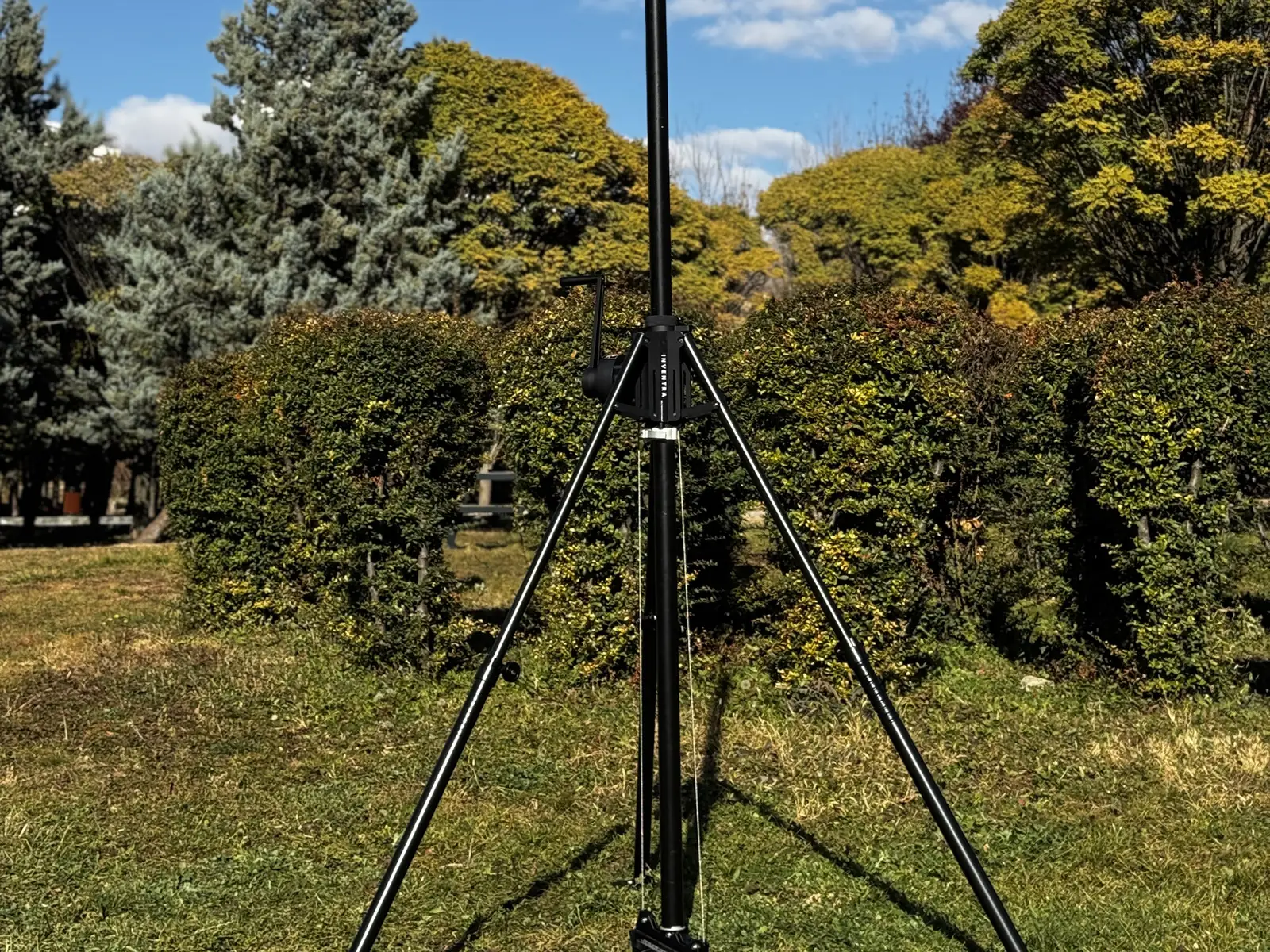 System set up in a garden: tripod, lower mast section and open sky