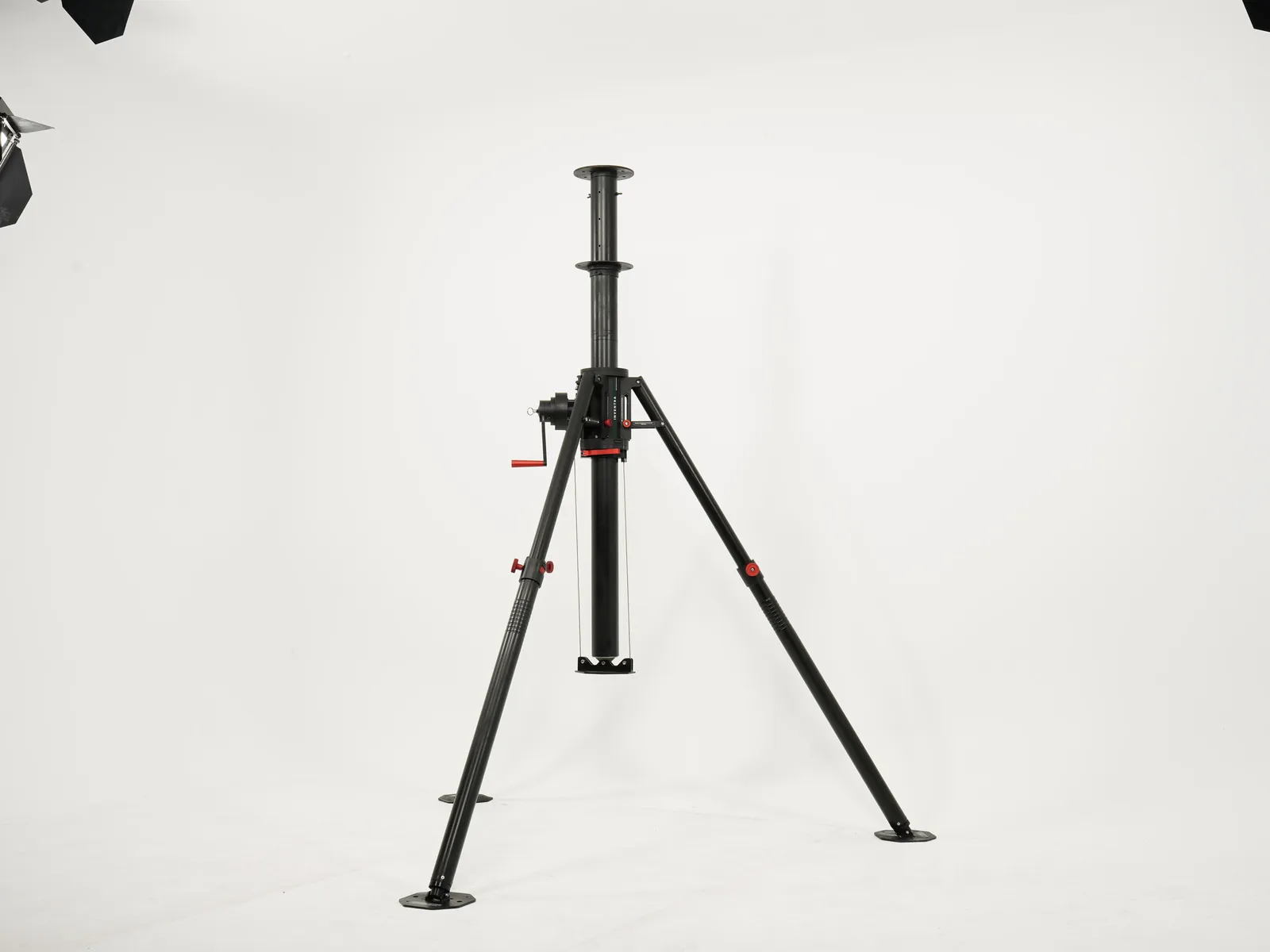 Heavy duty portable mast on its tripod, partly extended, on a plain studio background
