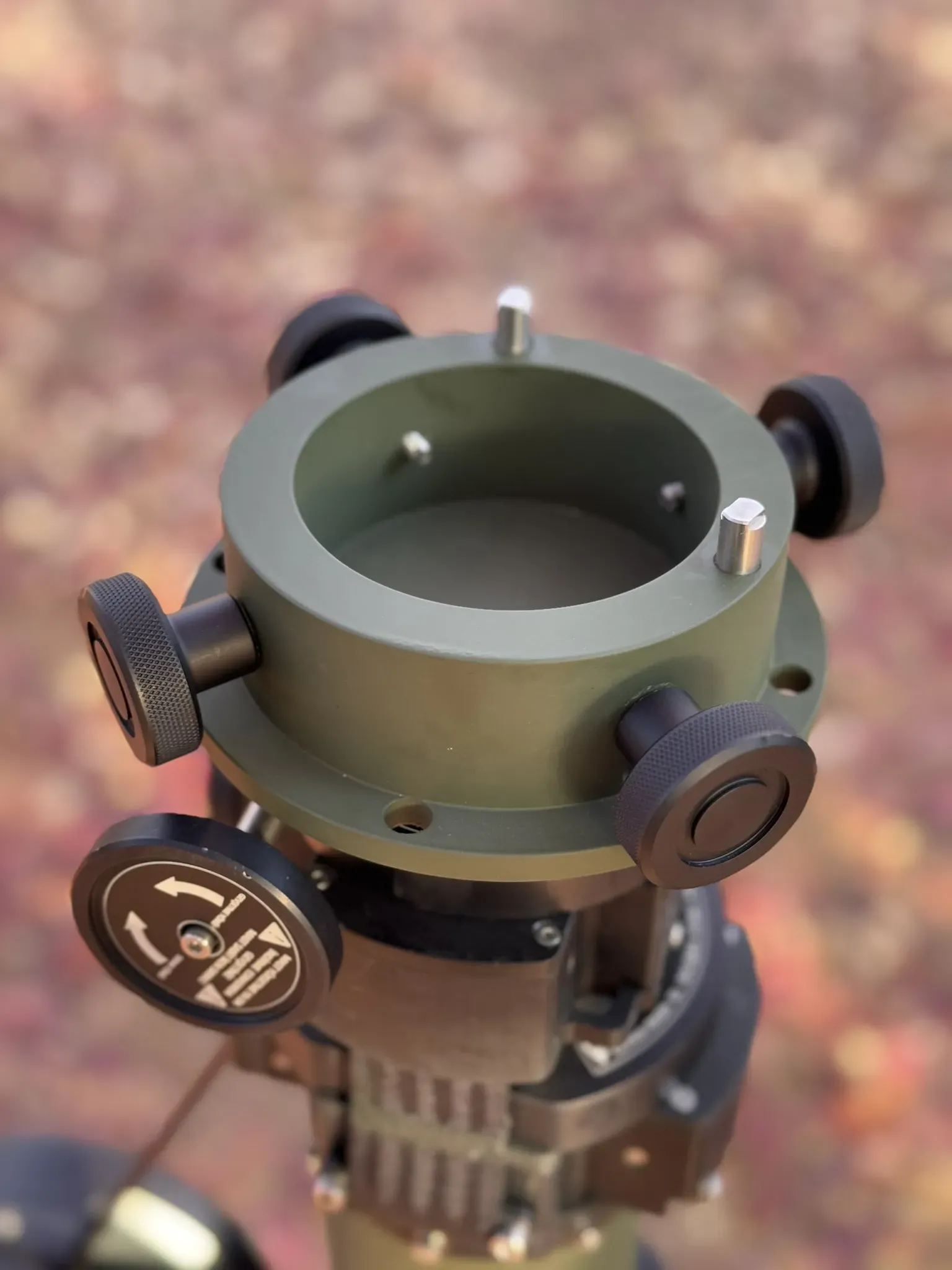 Top-down view into the empty circular payload mount ring with four locking knobs.
