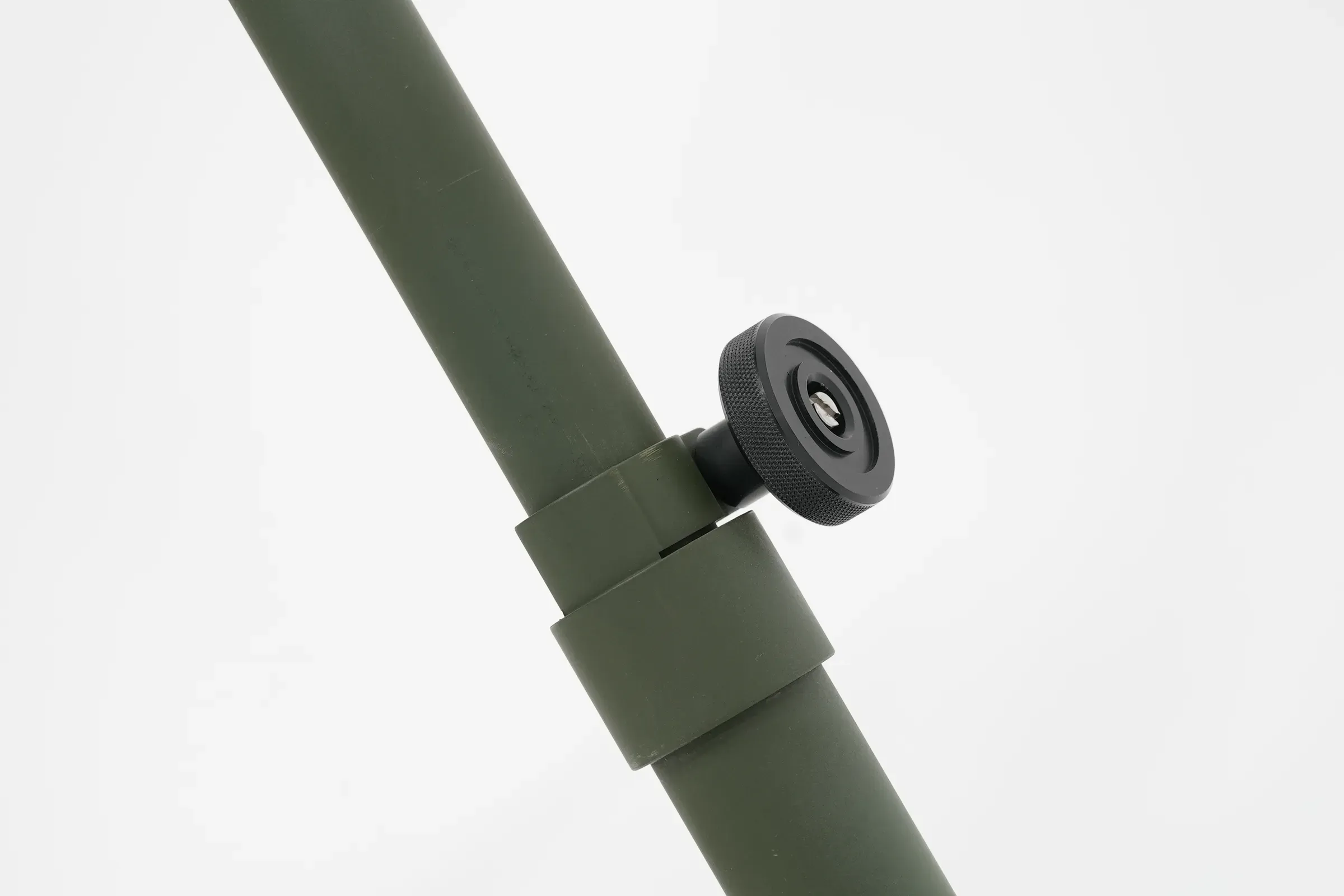 Angled tripod leg with its clamping collar and black locking knob against a light backdrop.