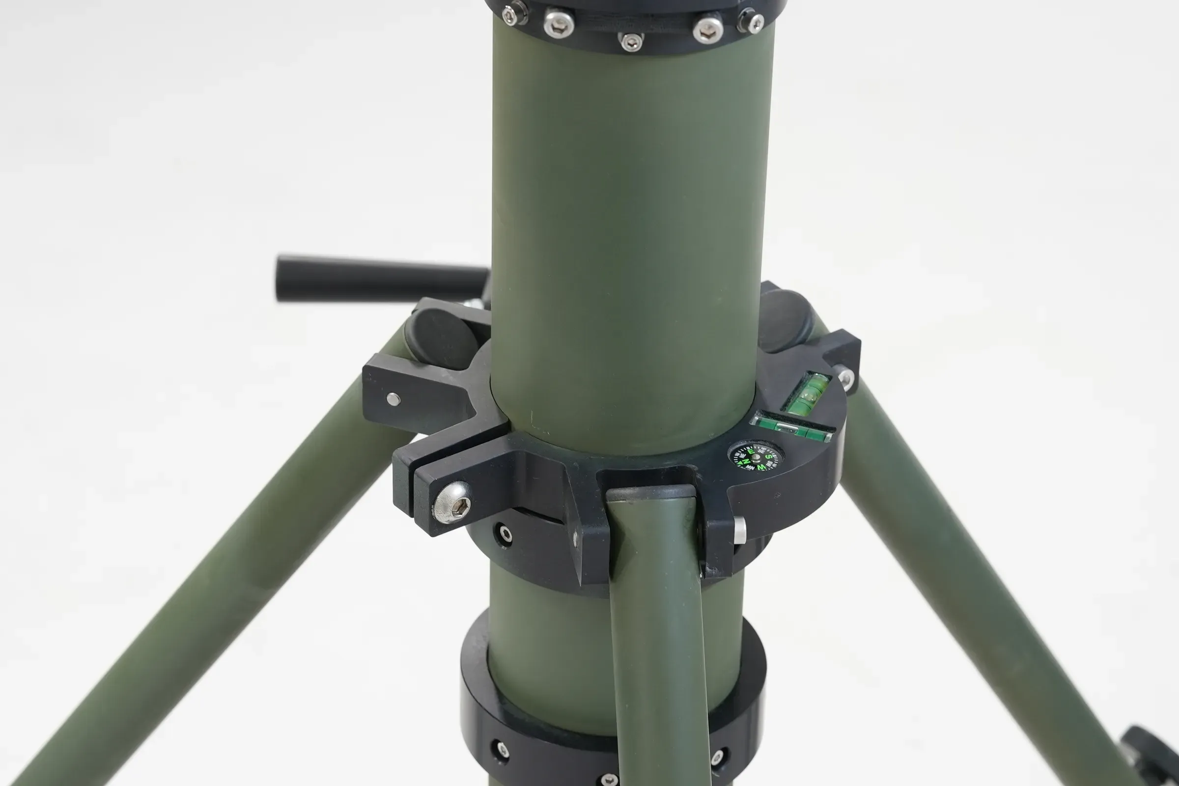 Close-up of olive green crane-arm mast collar clamp and locking lever where the tubular pole meets its tripod legs.