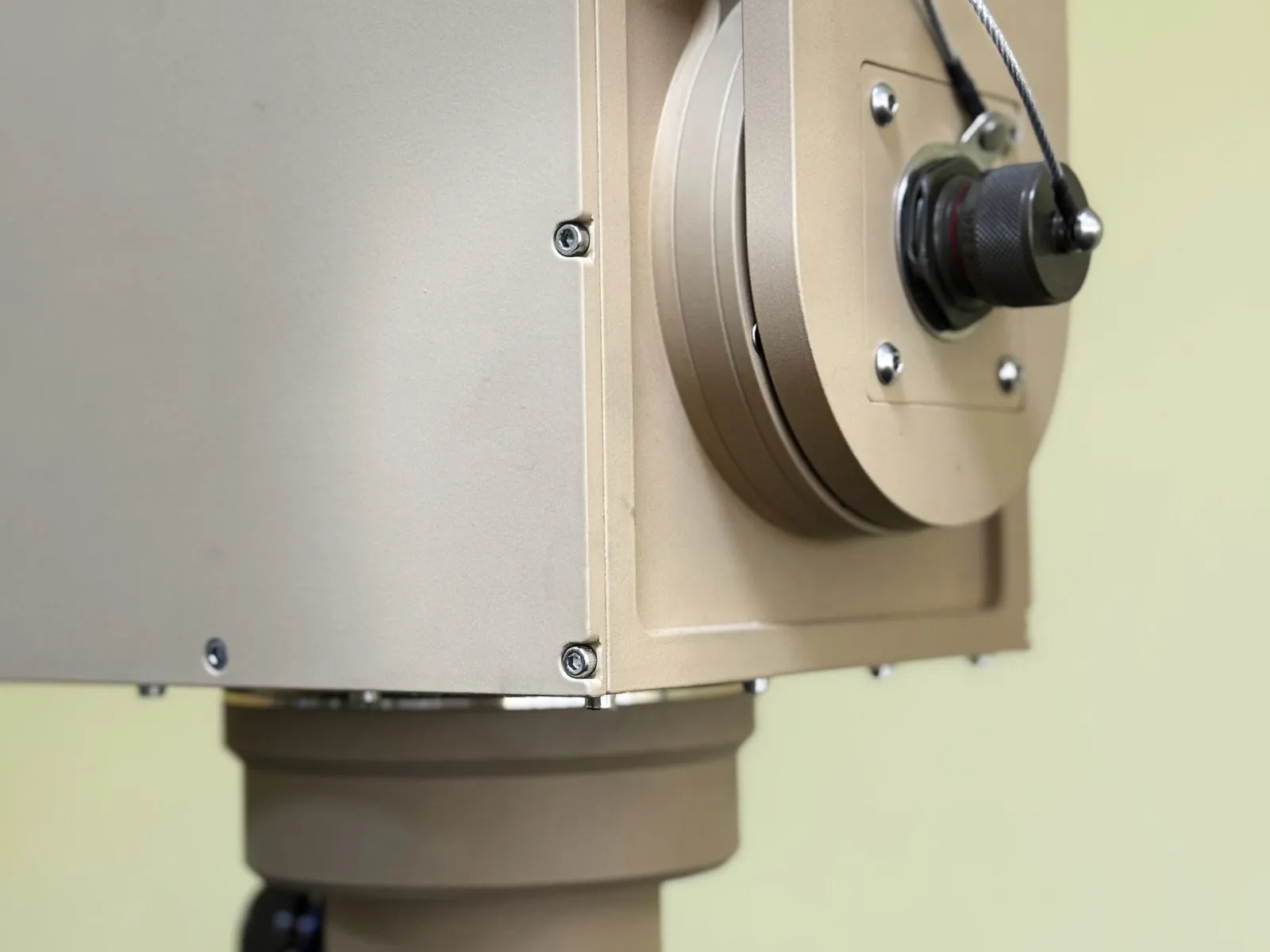 Close view of the side connector barrel with its tethered cover, the tilt disc and the azimuth base