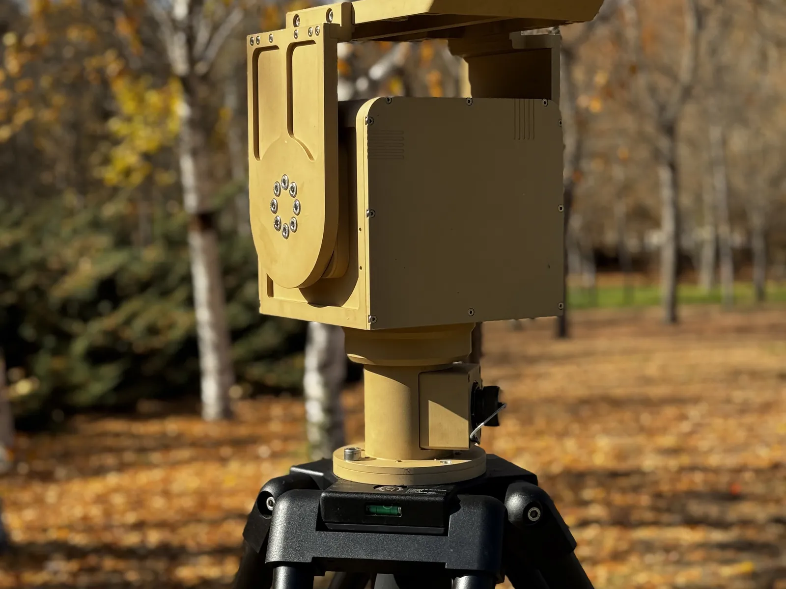 On a tripod in an autumn park, from a left-front three-quarter angle: sun shade, U-arm and column