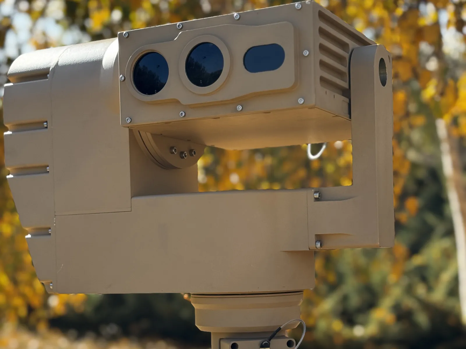 Tan U-type pan-tilt at front three-quarter, carrying a multi-channel imaging payload
