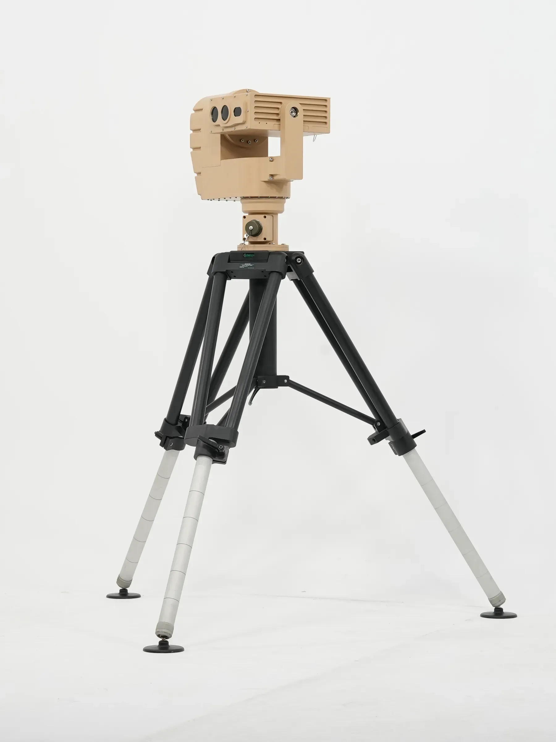 Full-length view of the tan PED12 positioner mounted on a black and silver tripod, front three-quarter angle.