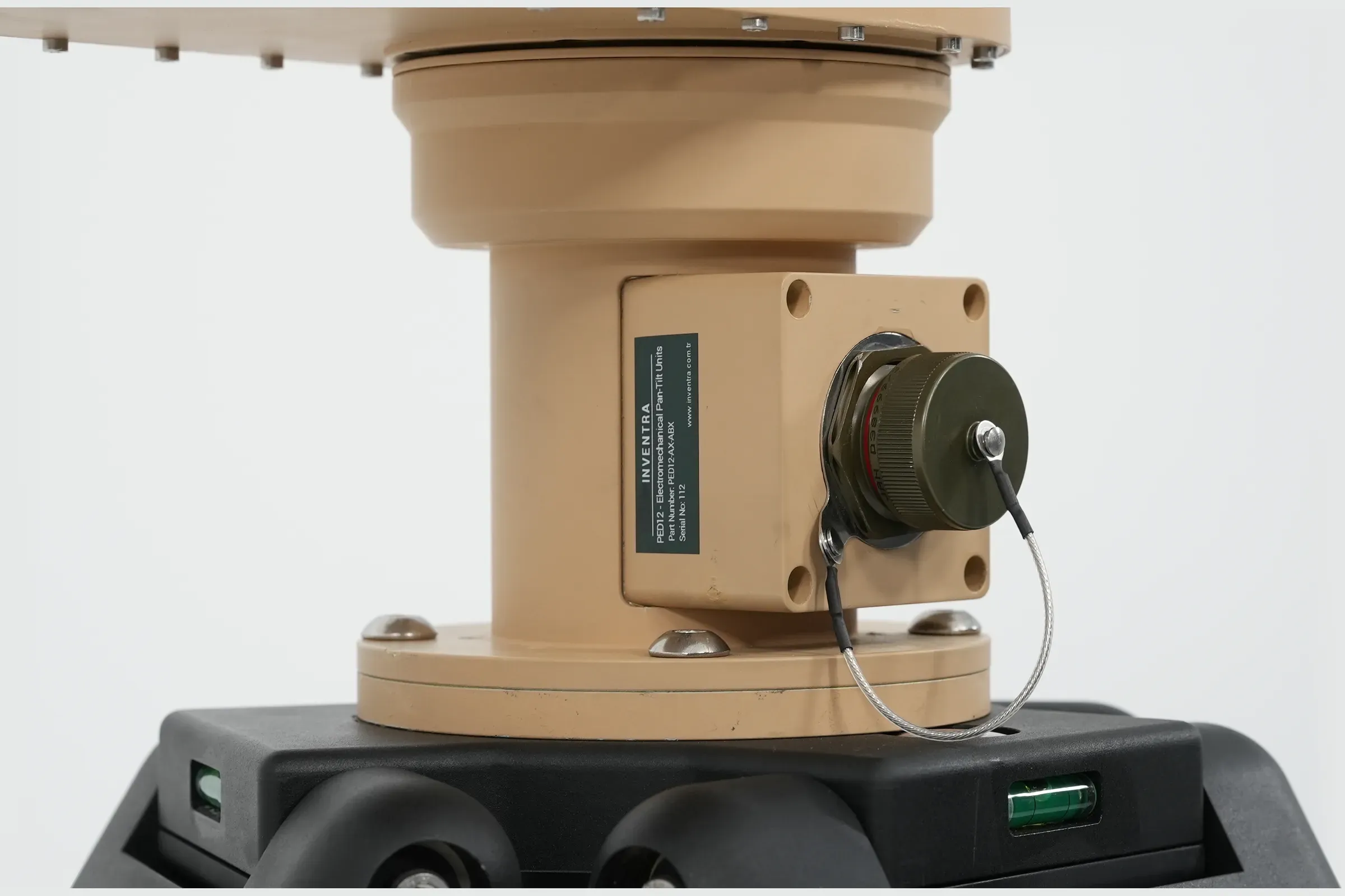 Detail of the tan PED12 azimuth base, mounting plate and circular connector above the black tripod head.