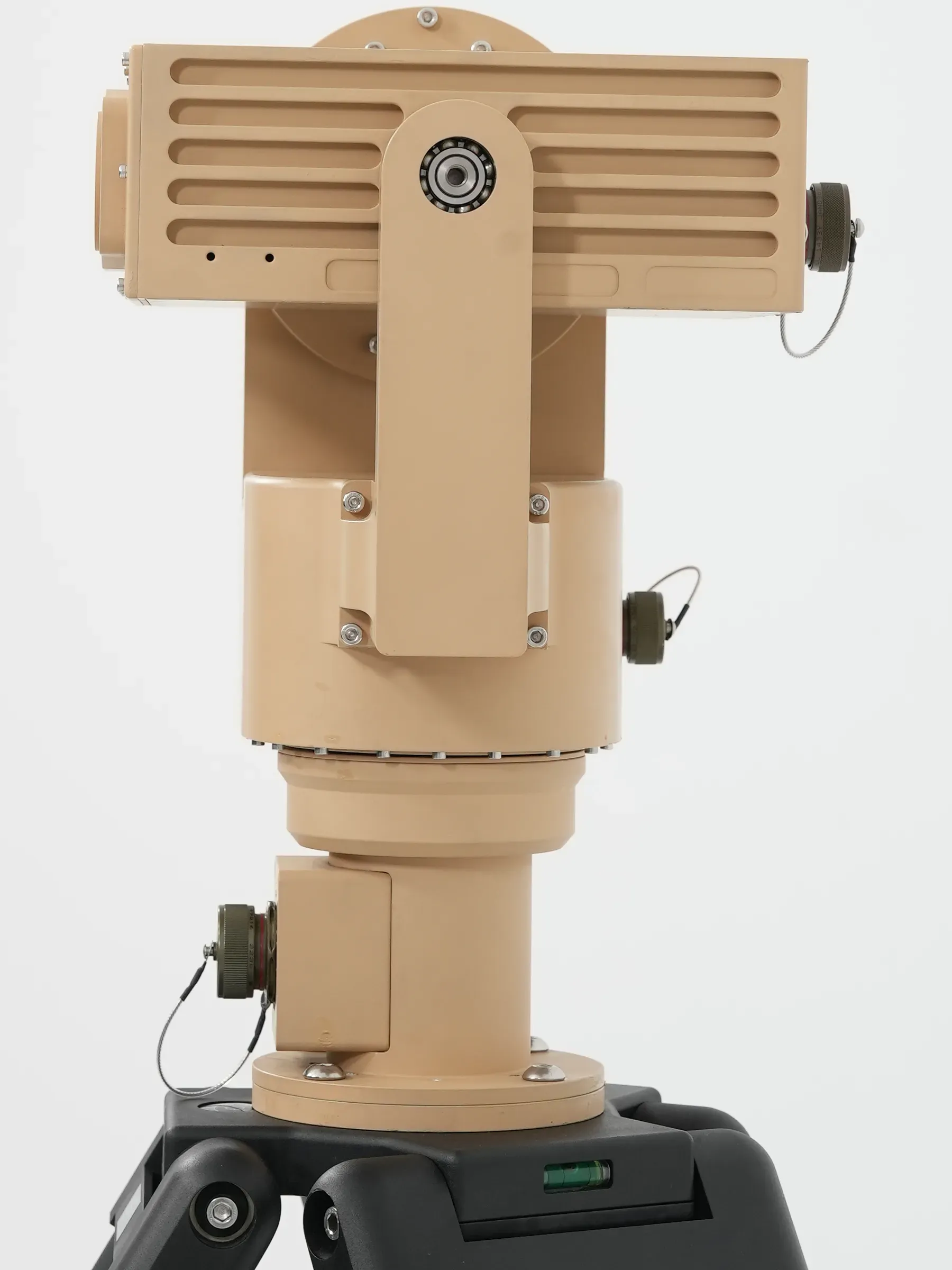 Rear view of the tan PED12 positioner on a tripod, showing the finned payload back panel and cabling.