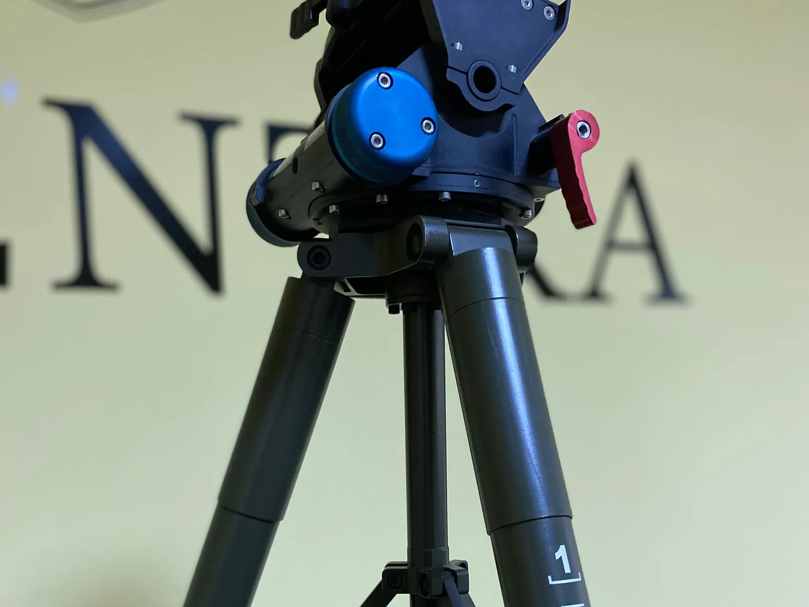 Right-front three-quarter with the head and tripod column together, locks in the open position