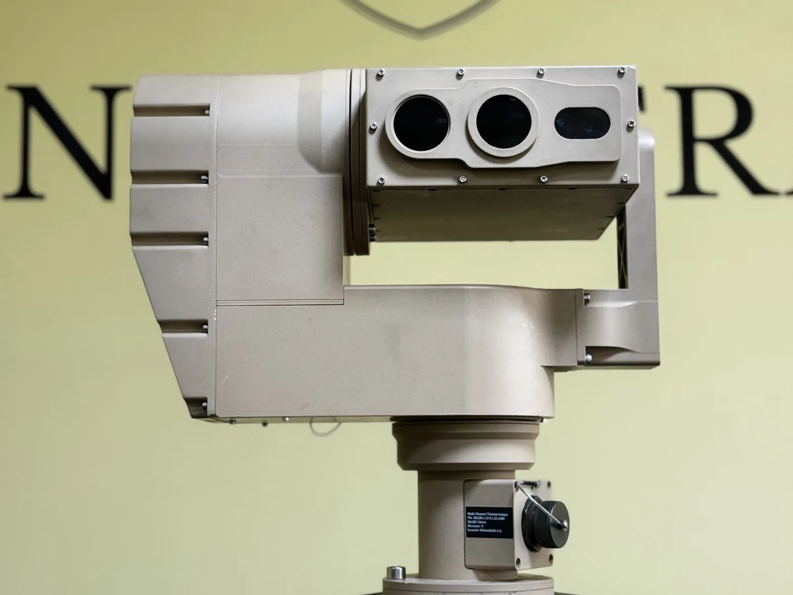 Multi channel thermal imager head on, showing its three optical apertures, mounted on a tripod