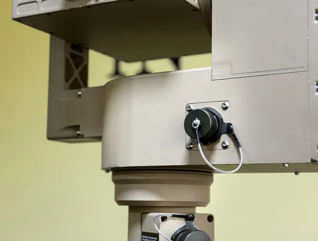 Close indoor view of the PED12 yoke, SEB20 finned housing and azimuth drive connectors above the tripod.