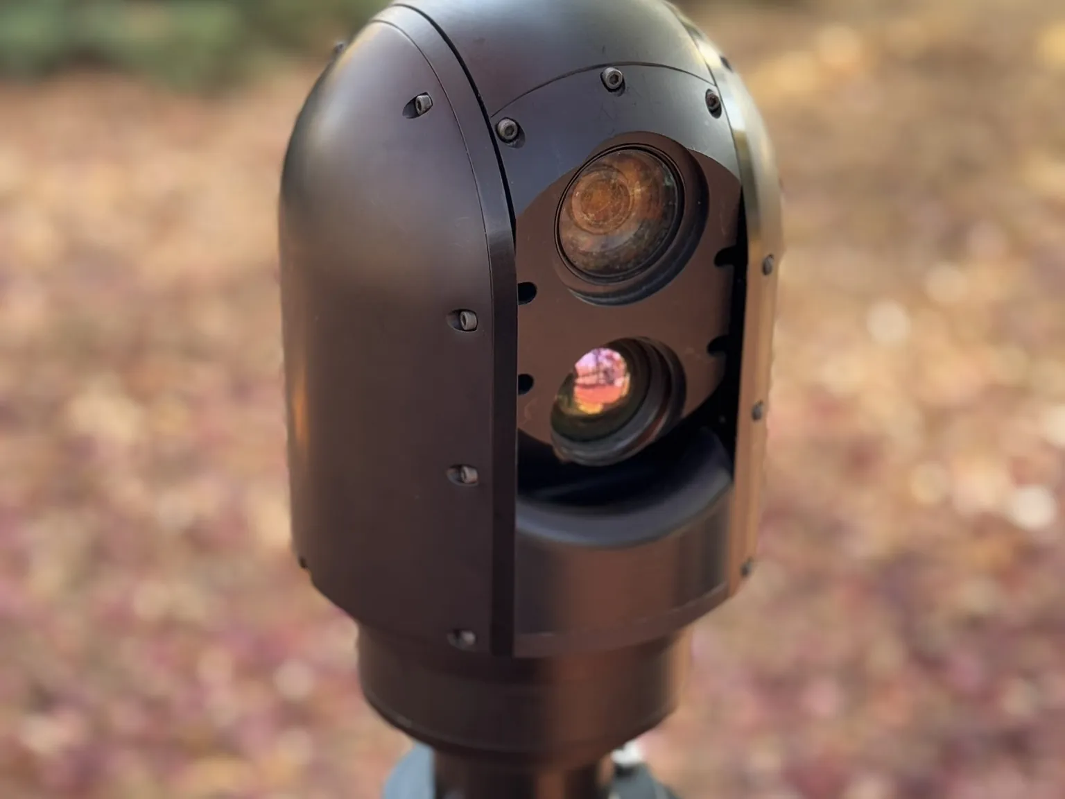 Rear-right face of the head: the closed dome housing and the scan slot