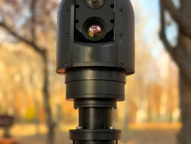 Front view of the SEG10 gimbal showing stacked day and thermal apertures above the mast joint.