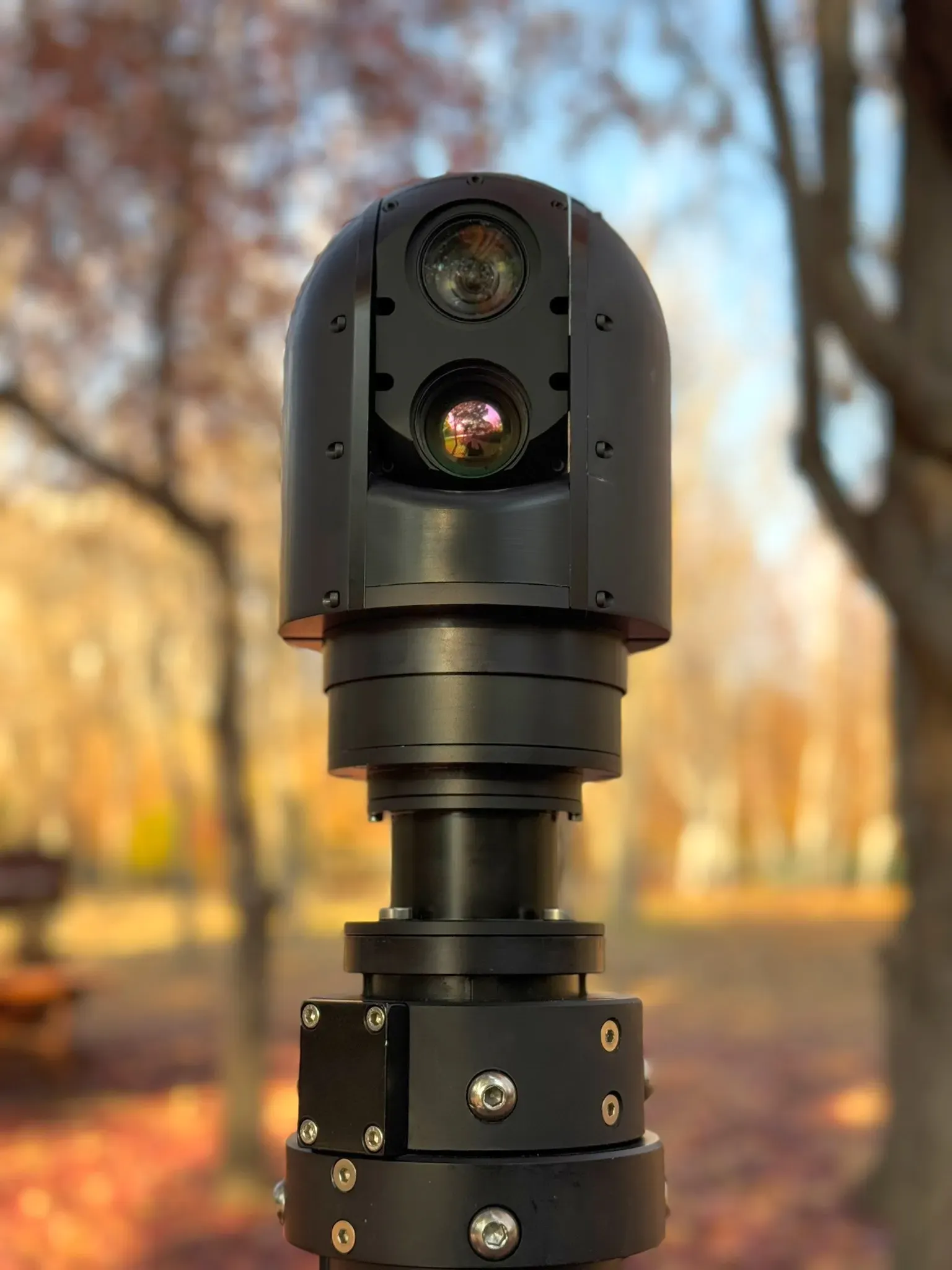 Front view of the SEG10 gimbal showing stacked day and thermal apertures above the mast joint.