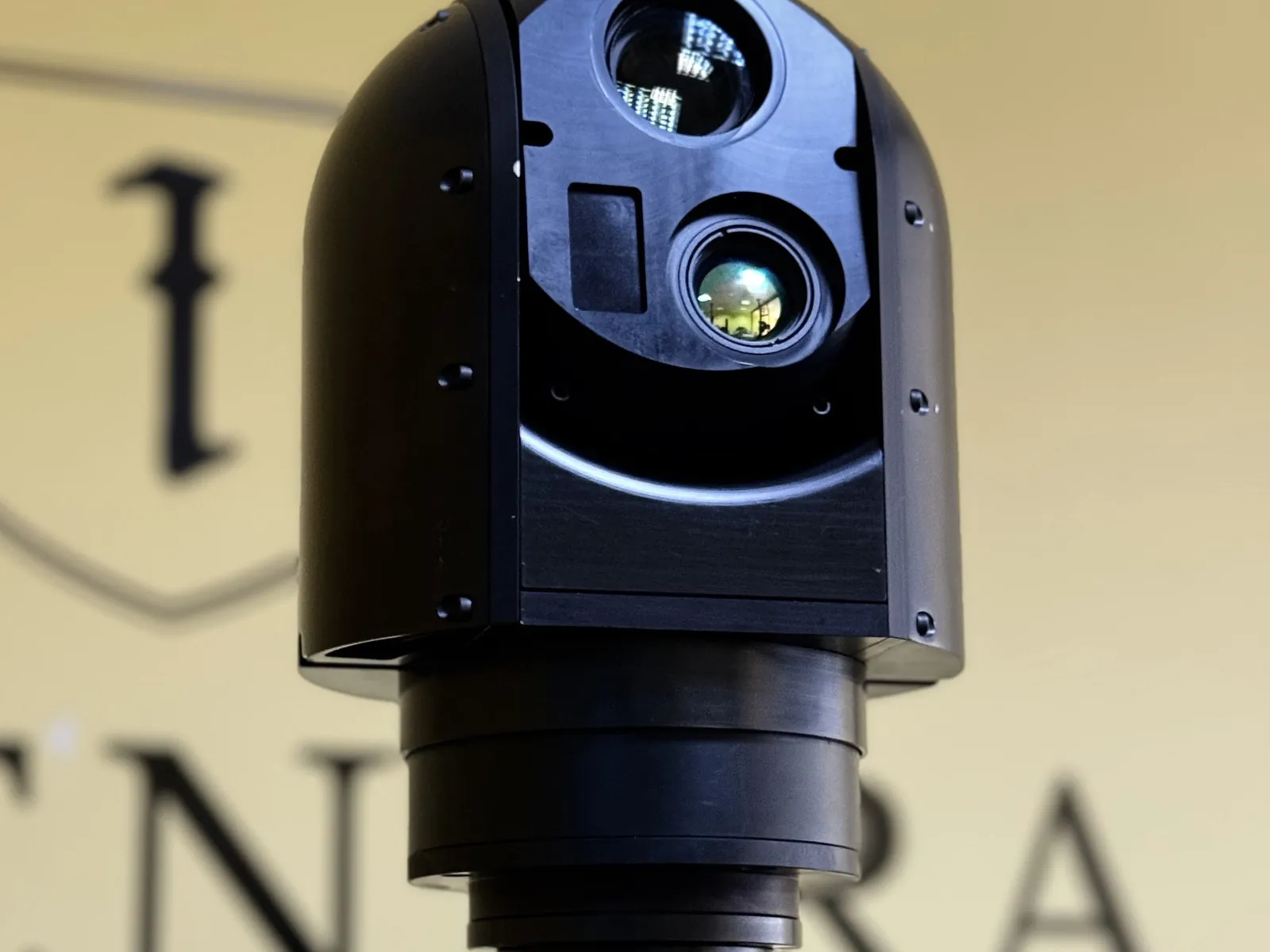 Multi channel gimbal from a left three-quarter angle: three optical channels and the mast clamps in one frame