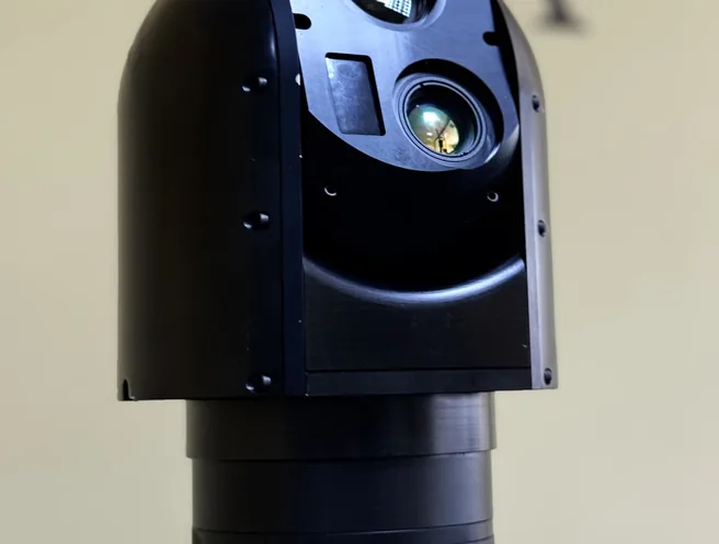 Upward angled close-up of the SEG12 gimbal head tilted forward on the mast collar.