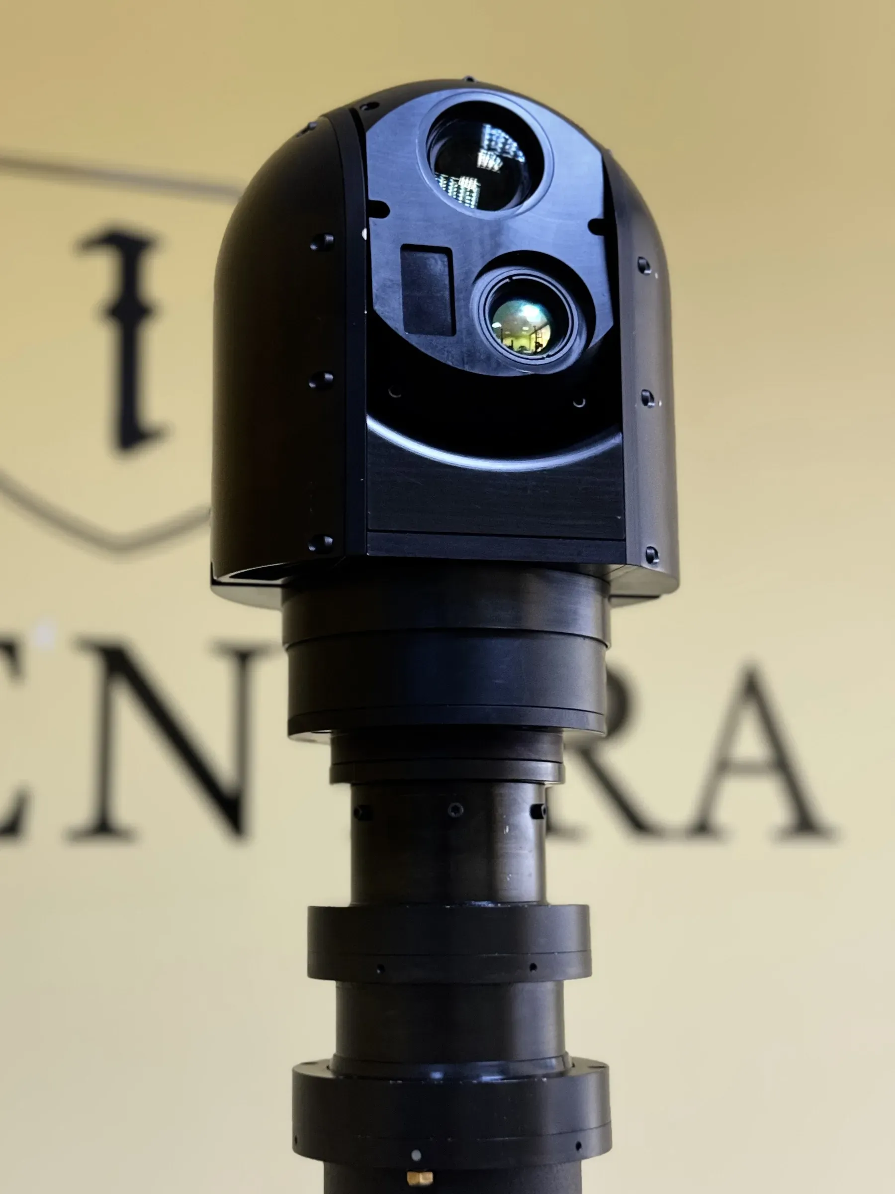 Close view of the SEG12 gimbal head on the mast top, laser and thermal apertures visible.