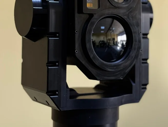 Front close-up of the SEG14 gimbal in its yoke showing large day lens and thermal aperture.