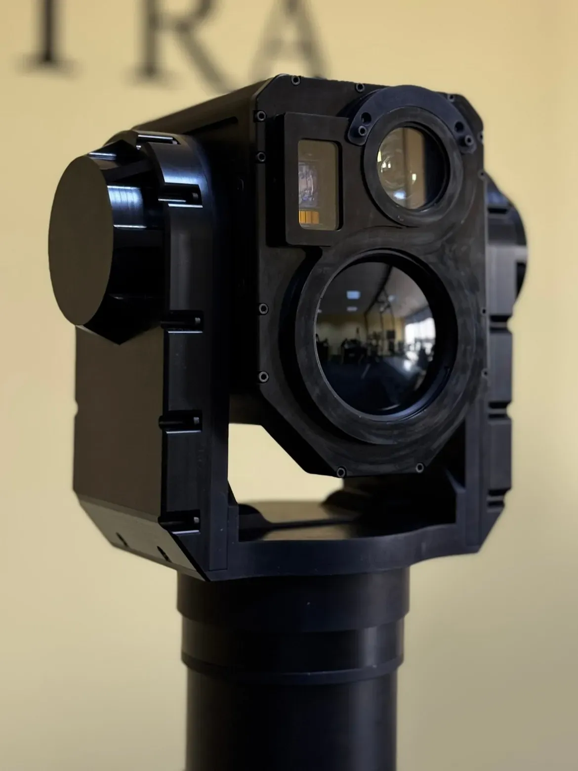 Front close-up of the SEG14 gimbal in its yoke showing large day lens and thermal aperture.