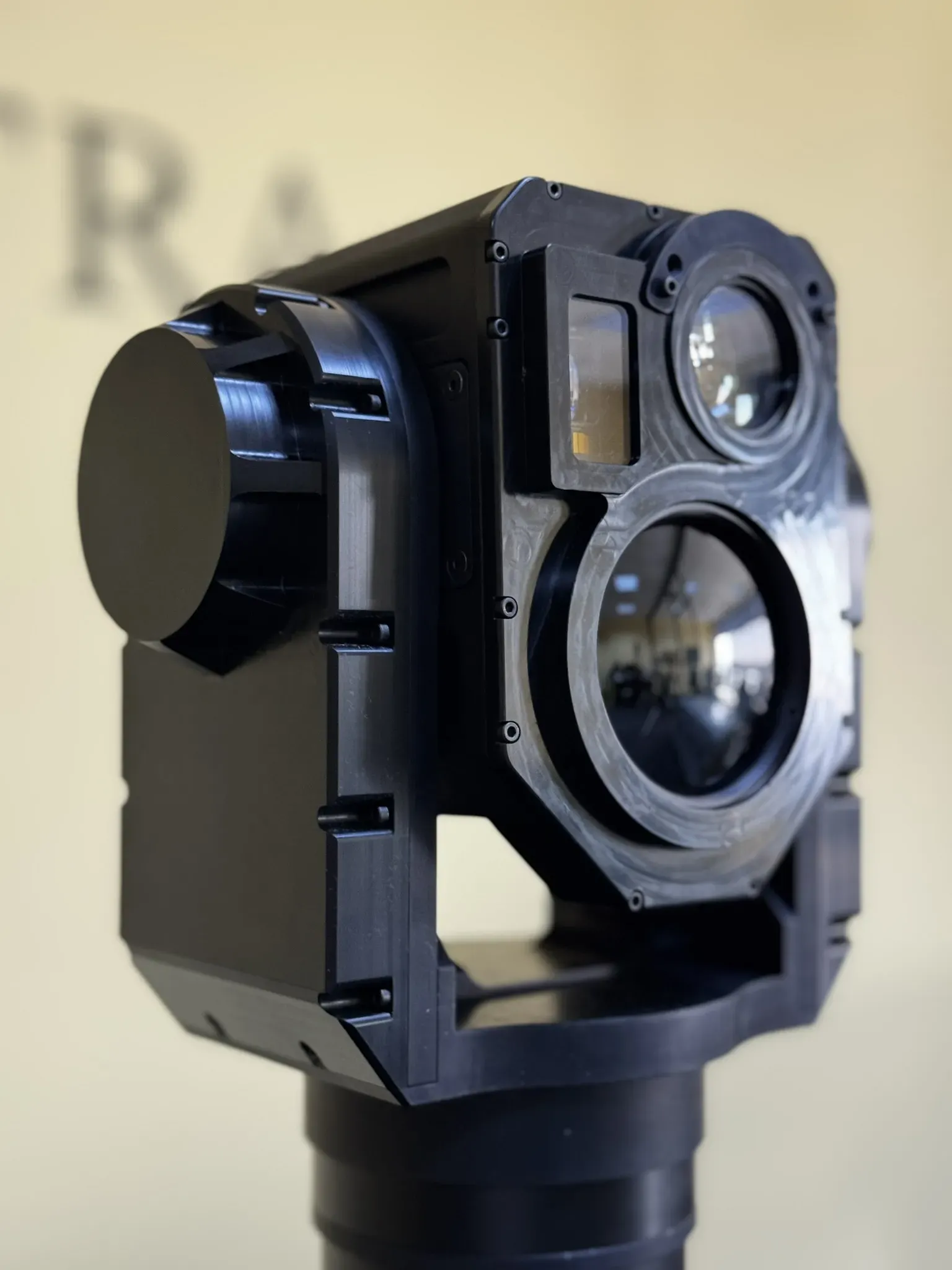 Angled close-up of the SEG14 gimbal showing lens barrels, laser window and side covers.