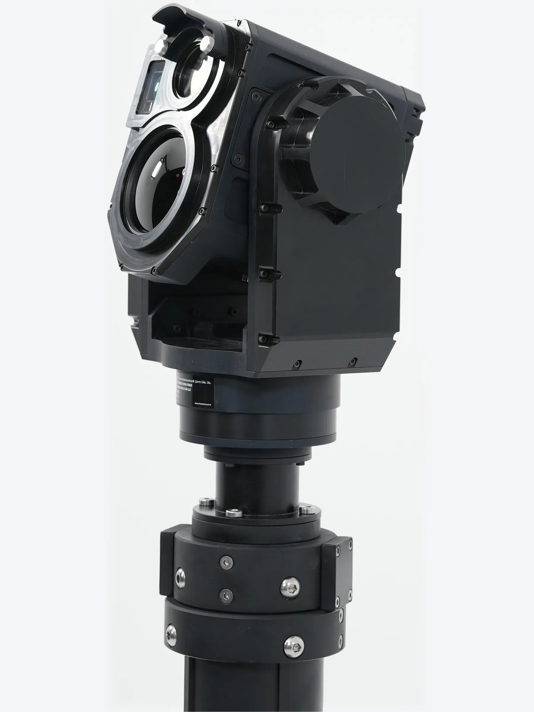 Close view of the SEG14 gimbal tilted on the mast top, optics angled toward camera.