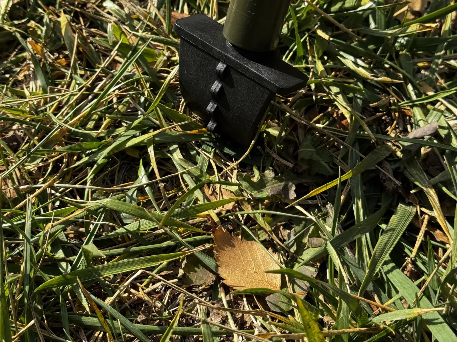 Spike foot driven into grass, showing grip on soft ground