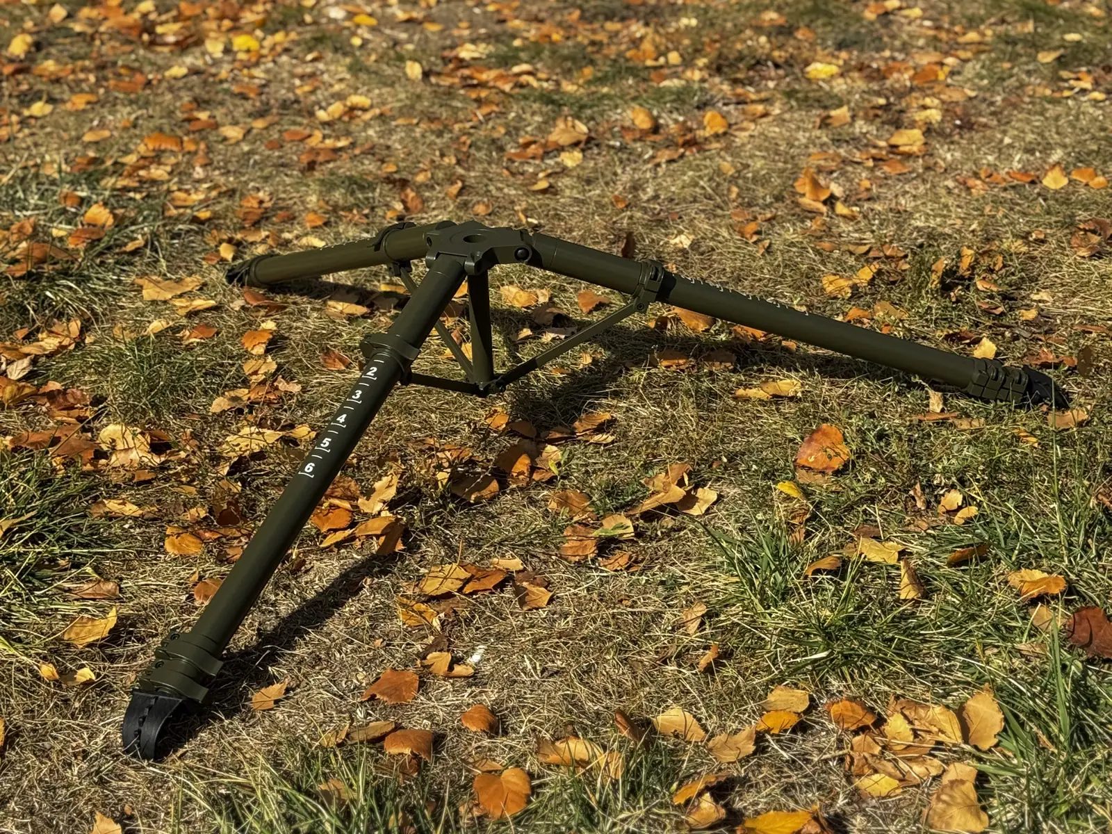 Tripod fully folded on the ground — transport volume and scale