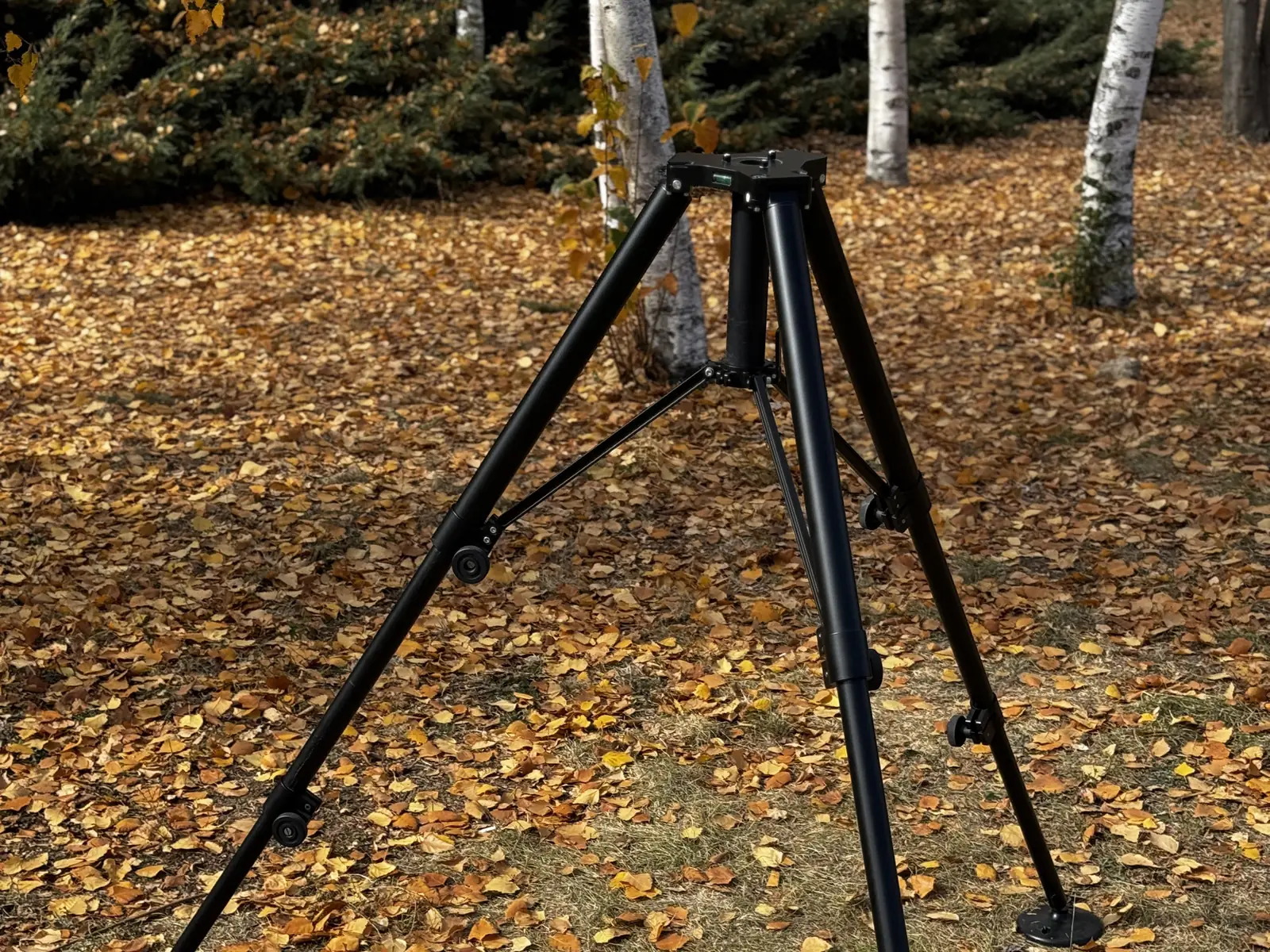 Tripod deployed in the field seen from the side: leg sections and brace arms